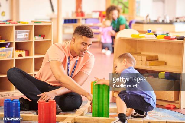 male nursery teacher - preschool stock pictures, royalty-free photos & images