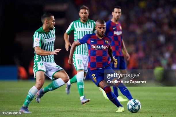 Rafinha of FC Barcelona competes for the ball with Alfonso Pedraza of Real Betis during the Liga match between FC Barcelona and Real Betis Balompie...