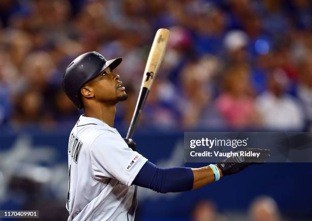 Keon Broxton of the Seattle Mariners hits a sacrifice fly as Daniel Volgelbach scores a run in the fourth inning during a MLB game against the...