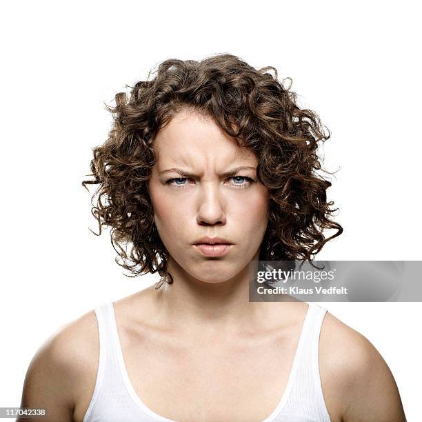 portrait of young woman looking angry - stirn runzeln stock-fotos und bilder