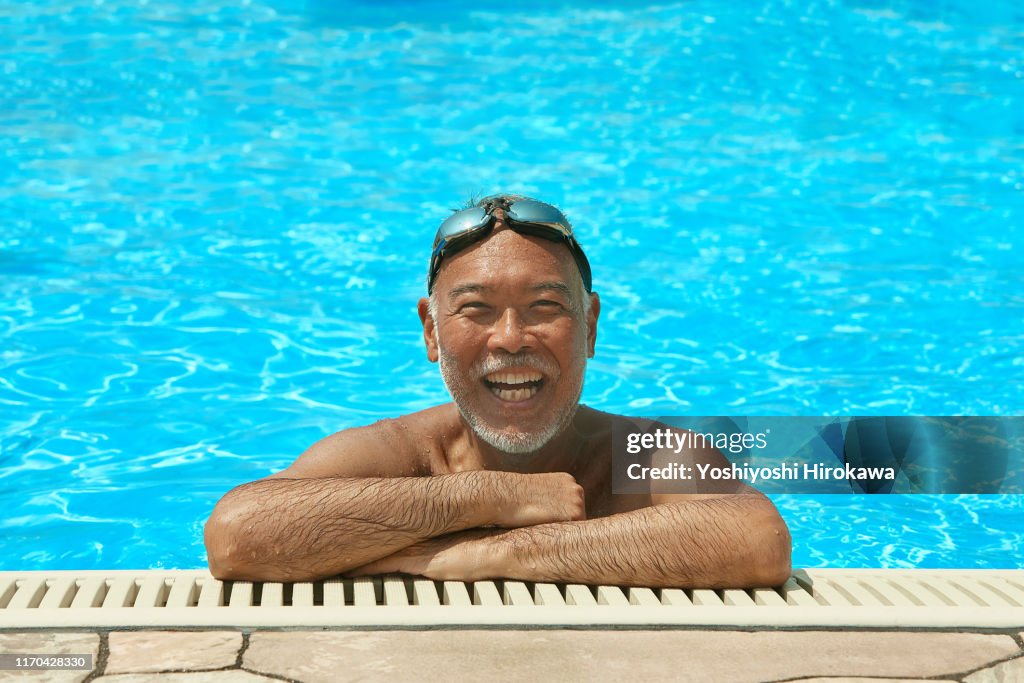 Smiling Senior Man on the rooftop pool