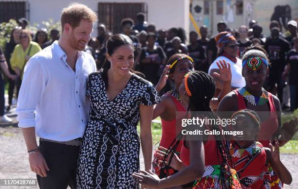 The Duke and Duchess of Sussex, Prince Harry and his wife Meghan interact with children during The Duke and Duchess of Sussex visit to Nyanga...