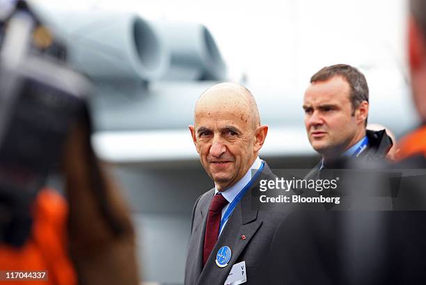 Louis Gallois, chief executive officer of European Aeronautic, Defense & Space Co., center, walks around the display area at the Paris Air Show in...