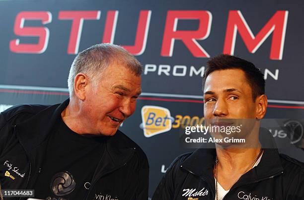 Felix Sturm of Germany and his coach Fritz Sdunek react during the Felix Sturm v Matthew Macklin press conference at Hotel Im Wasserturm on June 20,...