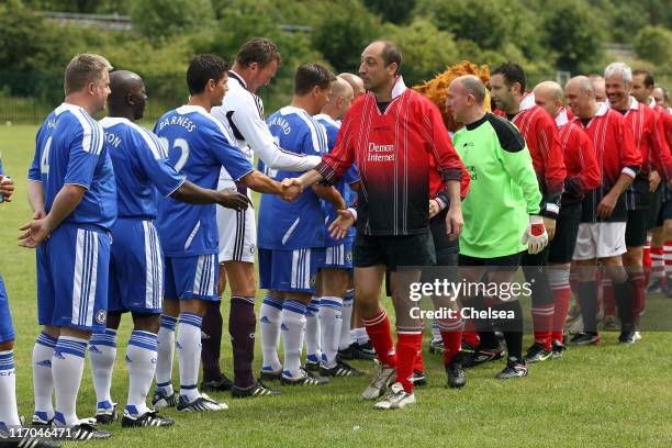 The teams shake hands prior to the start of the Chelsea Old Boys against KSHS XI Match on June 19, 2011 in Ilford, England.