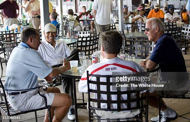 In this handout image provided by the White House, after playing a round of golf, U.S. President Barack Obama has a drink with Vice President Joe...