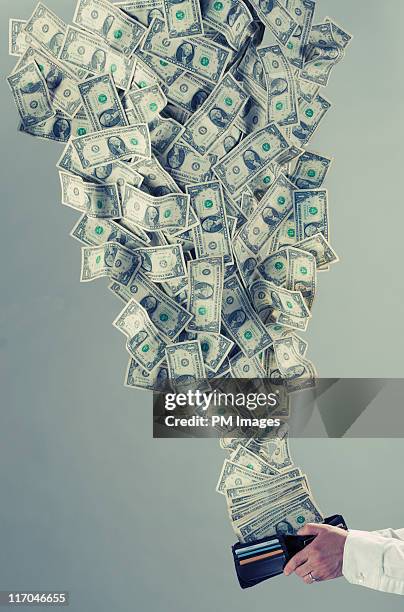 money flying out of man's wallet - wallet money stock pictures, royalty-free photos & images