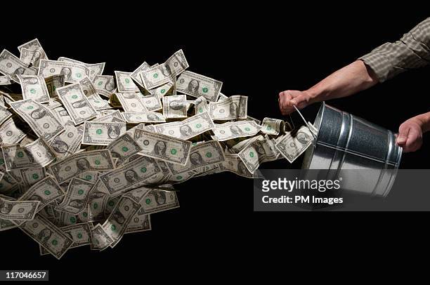 throwing bucket of money - 1 dollar schein stock-fotos und bilder