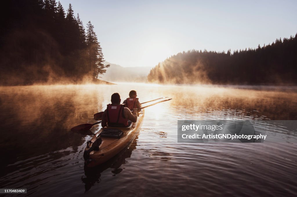 Kayaking on mountain lake.