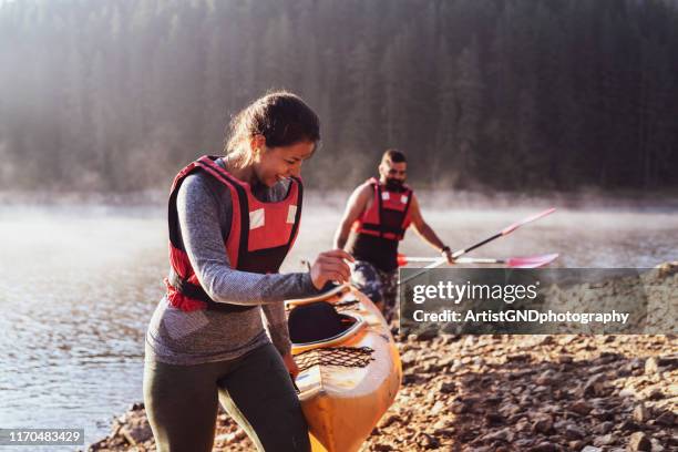 kayaking on mountain lake. - carrying kayak stock pictures, royalty-free photos & images