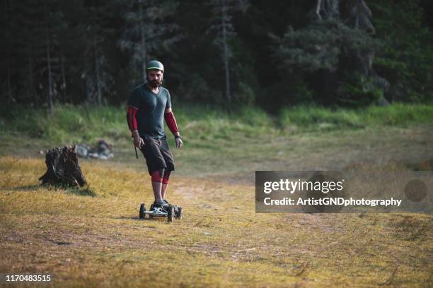 electric skateboarder outdoor - electric skateboard stock pictures, royalty-free photos & images