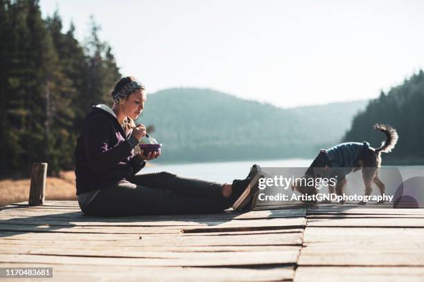 woman eating healthy food outdoor. - pier 1 stock pictures, royalty-free photos & images