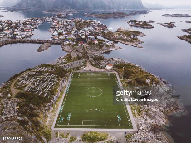 aerial view of a soccer field and a city in islands - aerial football photos et images de collection