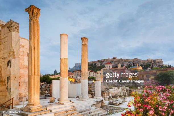 remains of hadrian's library and acropolis in the old town of athens. - plaka stockfoto's en -beelden