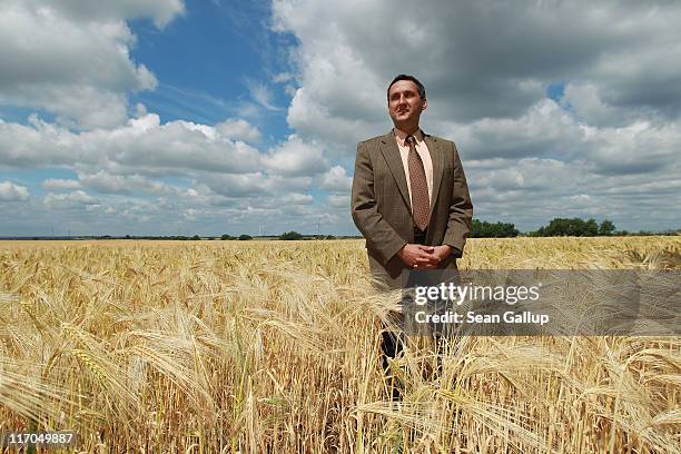 Michael Knape, mayor of Treuenbrietzen, which also includes the village of Feldheim, poses for a portrait in a field of barley on June 20, 2011 in...