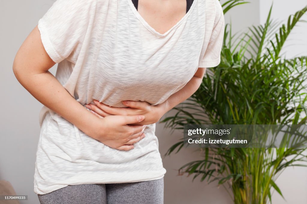 Young woman have stomach ache
