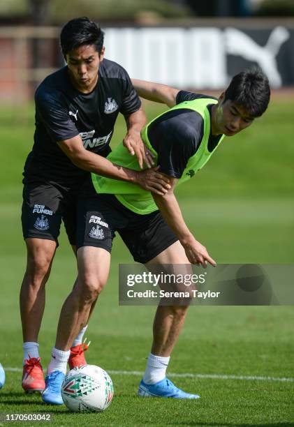 Yoshinori Muto and Ki Sung-Yueng jostle for the ball during the Newcastle United Training Session at the Newcastle United Training Centre on August...