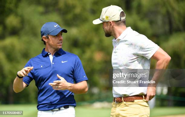 Musician Justin Timberlake and Rory McIlroy of Northern Ireland share a joke during practice prior to the start of the Omega European Masters at...