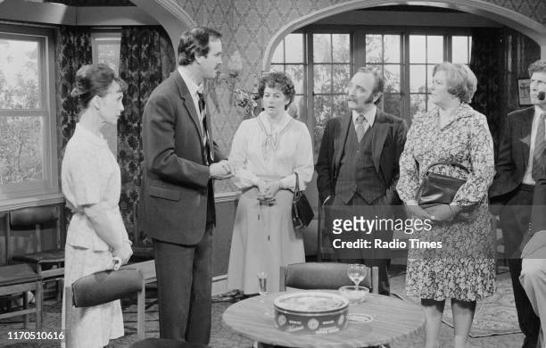 Actors Una Stubbs, John Cleese, Denyse Alexander, Roger Hume, Pat Keen and Robert Arnold in a scene from episode 'The Anniversary' of the BBC...