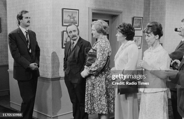 Actors John Cleese, Roger Hume, Pat Keen, Denyse Alexander, Una Stubbs and Robert Arnold in a scene from episode 'The Anniversary' of the BBC...