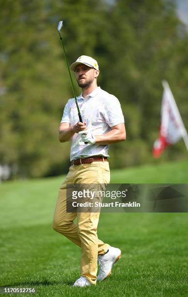 Musician Justin Timberlake plays a shot during practice prior to the start of the Omega European Masters at Crans Montana Golf Club on August 27,...