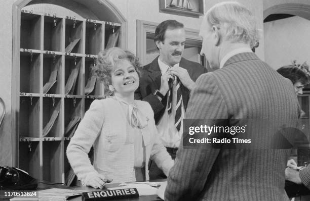 Actors Prunella Scales, John Cleese and Mervyn Pascoe in a scene from episode 'Communication Problems' of the BBC television sitcom 'Fawlty Towers',...