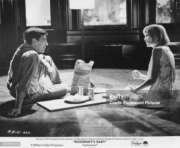 American actor, director and screenwriter John Cassavetes stars with Mia Farrow in the film 'Rosemary's Baby', 1967. Here the young couple eat dinner...
