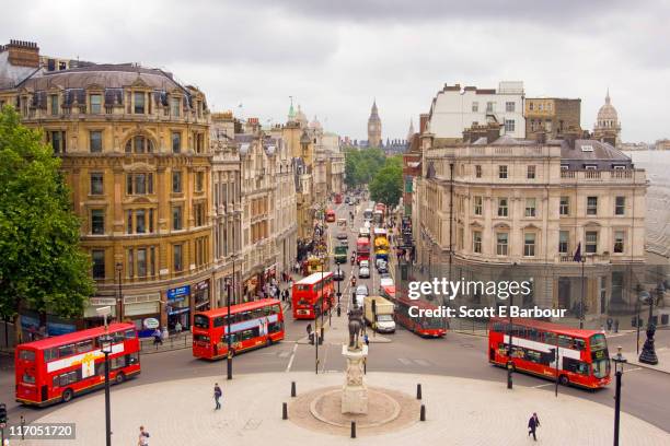 view down whitehall of buses and big ben - city government stock pictures, royalty-free photos & images