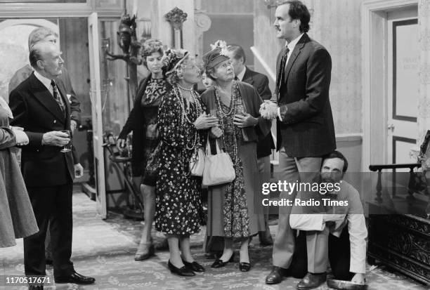 Actors Ballard Berkeley, Iris Fry, Gilly Flower, Renee Roberts, John Lawrence , John Cleese and Andrew Sachs in a scene from episode 'The Germans' of...