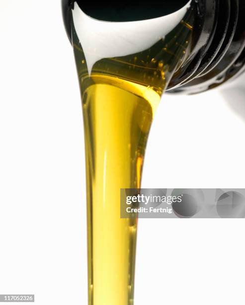 engine oil and bottle - pouring motor oil stock pictures, royalty-free photos & images