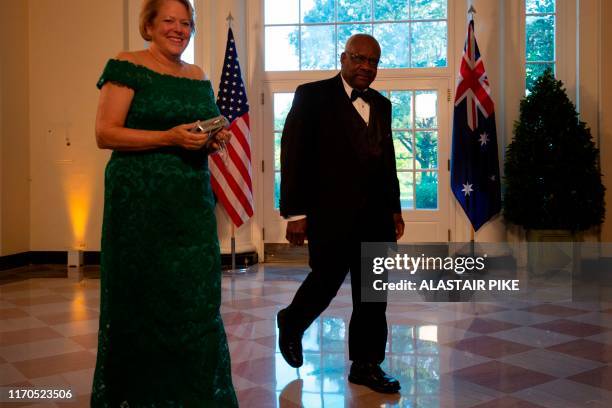 Supreme Court Justice Clarence Thomas and his wife Virginia arrive in the Booksellers area of the White House to attend a state dinner honoring...