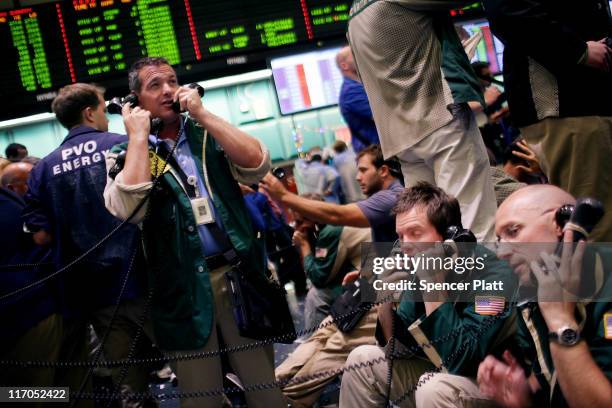 Traders work in the crude oil and natural gas options pit on the floor of the New York Mercantile Exchange on June 20, 2011 in New York City....