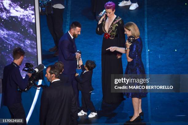 Best FIFA Men's Player of 2019, Argentina and Barcelona forward Lionel Messi , reacts with one of his children, as Best FIFA Women's Player of 2019,...