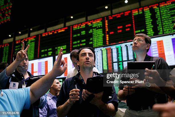 Traders work in the crude oil and natural gas options pit on the floor of the New York Mercantile Exchange on June 20, 2011 in New York City....