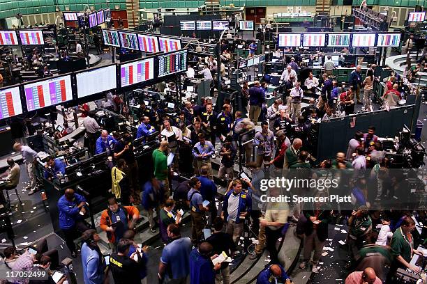 Traders work in the crude oil and natural gas options pit on the floor of the New York Mercantile Exchange on June 20, 2011 in New York City....