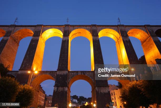 historic viaduct floodlit at dusk. - viaduct stock-fotos und bilder