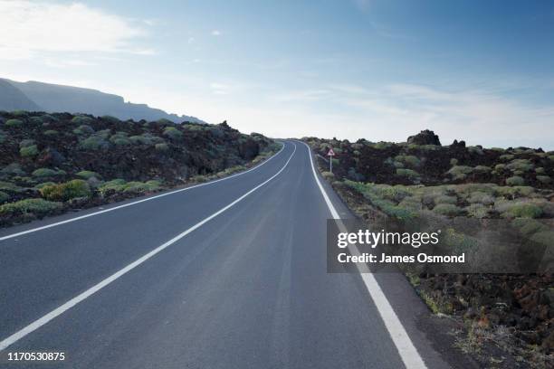 empty road through volcanic landscape. - empty road ストックフォトと画像