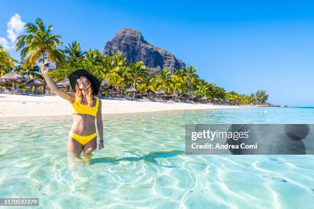 a tourist is taking a selfie at a tropical beach - isole mauritius stock pictures, royalty-free photos & images