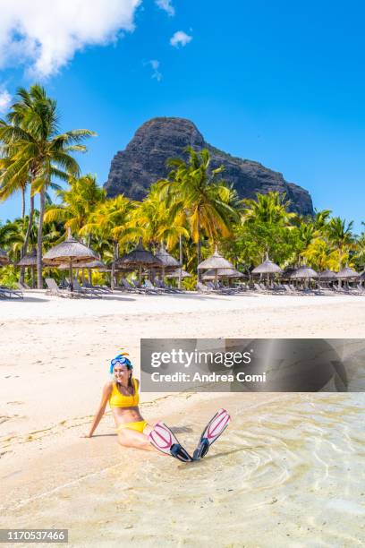 portrait of a young woman wearing diving flippers and mask, in a tropical beach - mauritius stock pictures, royalty-free photos & images