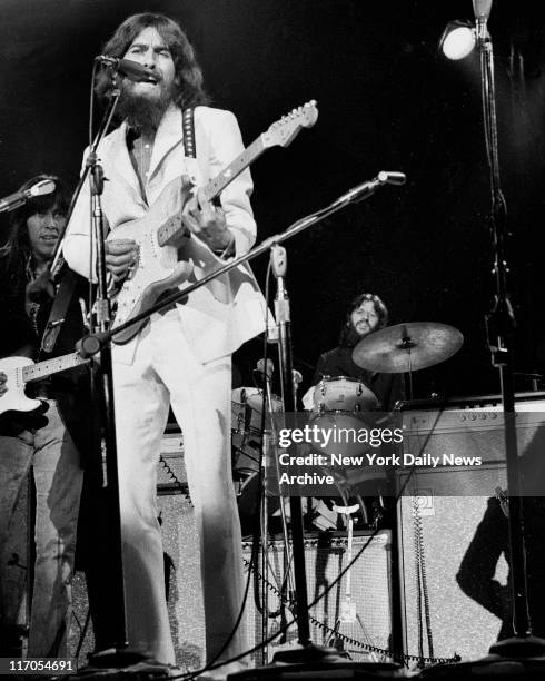 George Harrison on guitar and Ringo Starr on drums belt out some of the songs made famous by the Beatles before capacity crowd attending afternoon...