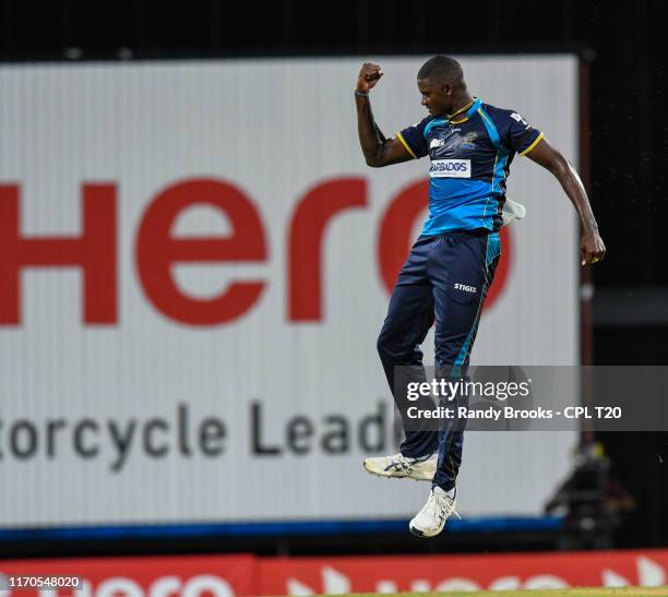 In this handout image provided by CPL T20, Jason Holder of Barbados Tridents celebrates the dismissal of Chris Gayle of Jamaica Tallawahs during...