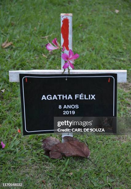 Cross in memory of eight-year-old Agatha Sales Felix is seen after being planted by the NGO Rio de Paz during a protest against the death of Agatha...