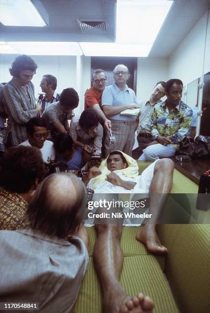 Muhammad Ali fields questions from the Filipino and International Press as he relaxes in his dressing room after training session days before his...