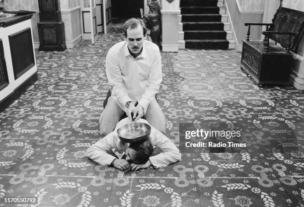 Actors Andrew Sachs and John Cleese in a scene from episode 'The Wedding Party' of the BBC television sitcom 'Fawlty Towers', August 10th 1975.