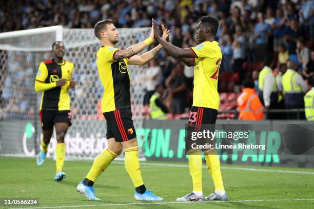 Ismaila Sarr of Watford celebrates scoring his side's first goal with team mate Daryl Janmaat during the Carabao Cup Second Round match between...