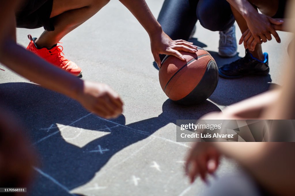 Coach explaining game plan to basketball players