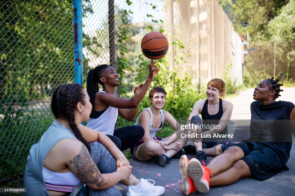 Female basketball players relaxing after practice