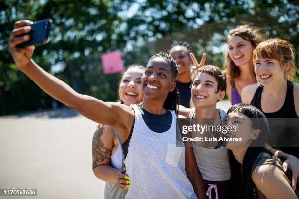 female basketball players posing for a selfie - young athletes stock pictures, royalty-free photos & images
