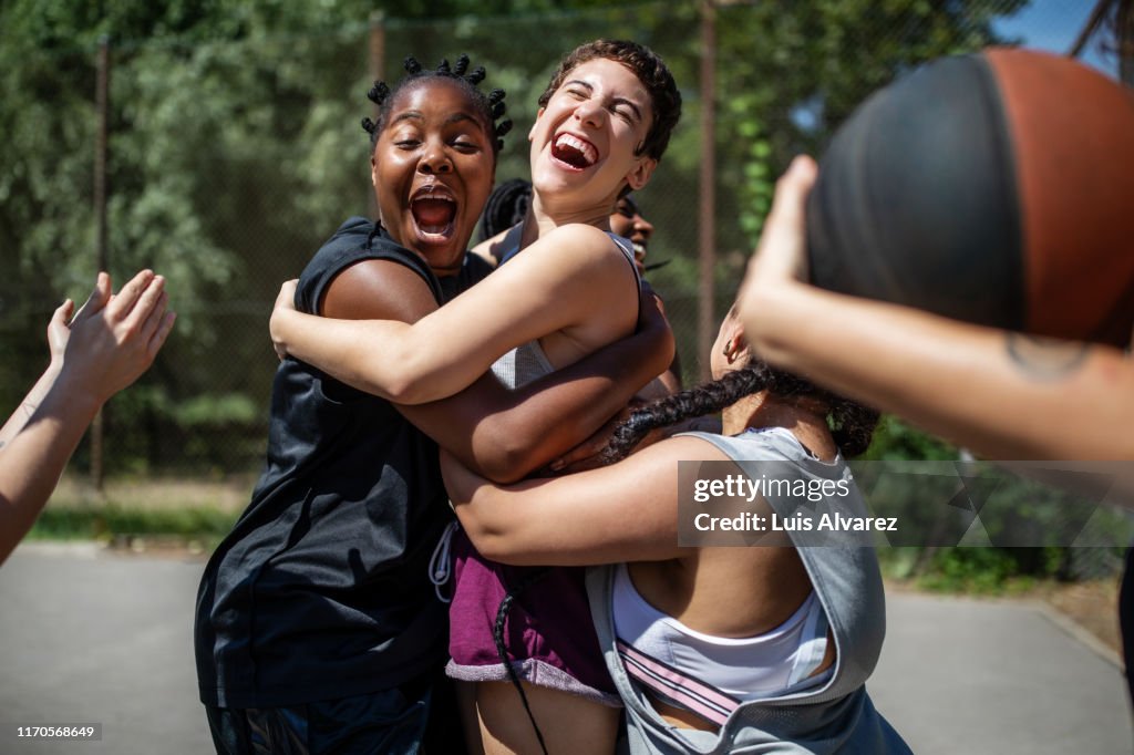 Female basketball team celebrating a victory