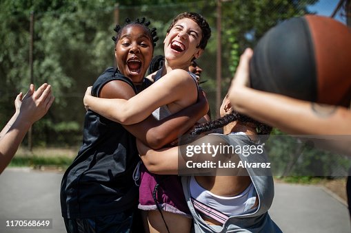 Female basketball team celebrating a victory Female basketball team celebrating a victory